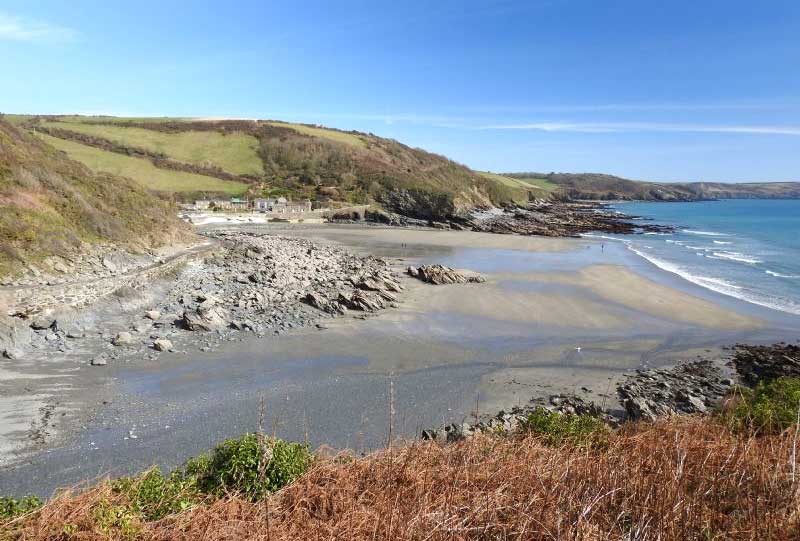 10 Best Dog Friendly Beaches in Cornwall - Portholland West in the foreground and East with its shop and refreshments in the background.