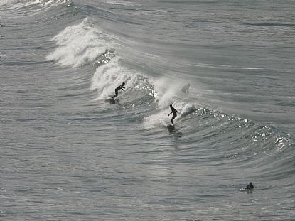Surfers at Holywell Bay